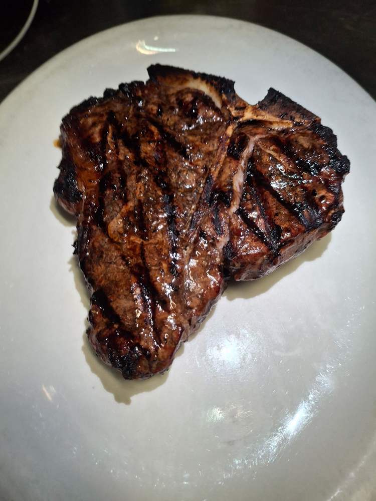 Perfectly grilled porterhouse steak from J&R's Steakhouse, Long Island.